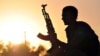 FILE - A fighter from the Kurdish People Protection Unit (YPG) waits in the Syrian town of Ain Issi, north of Raqqa, during clashes between IS group jihadists and YPG fighters, July 10, 2015. 