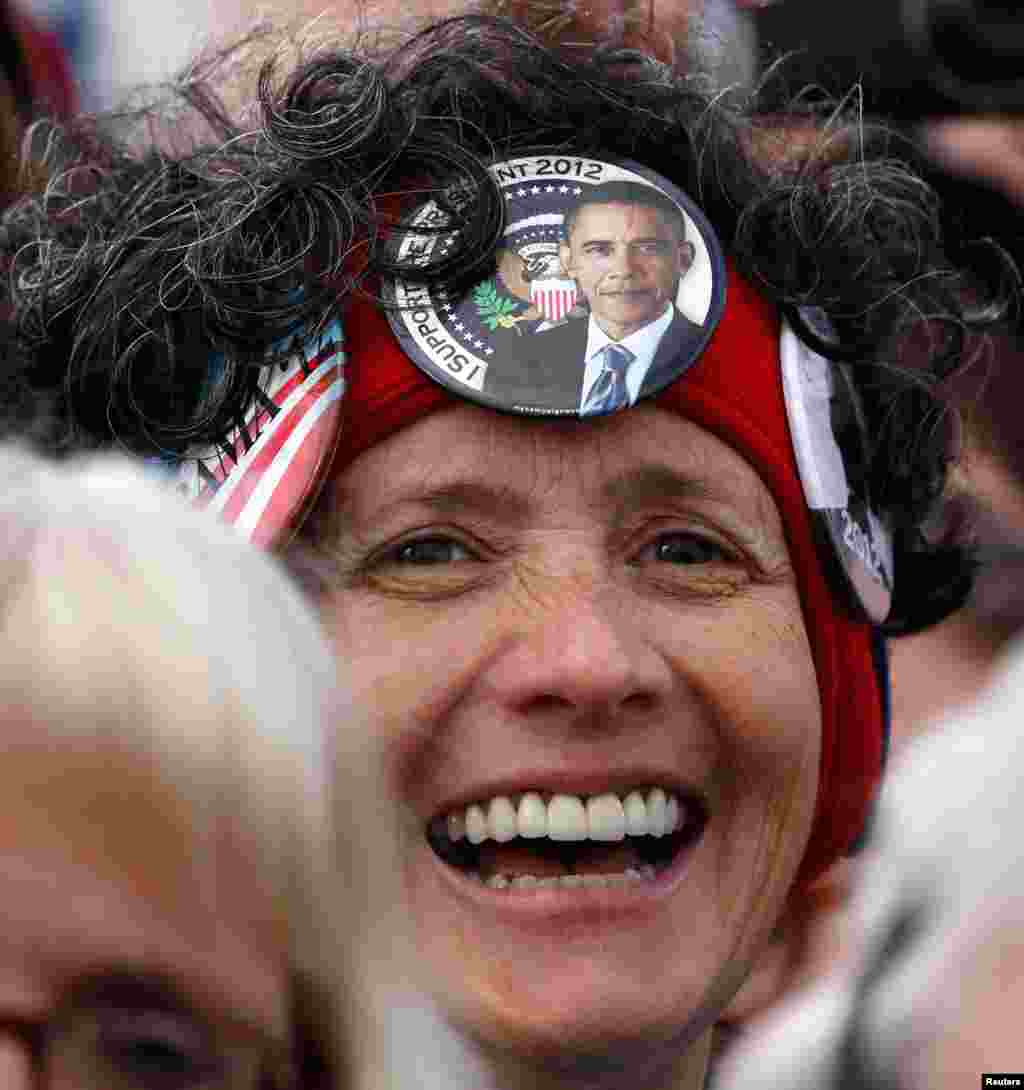 A supporter listens to President Obama at a campaign event at Austin Straubel International Airport in Green Bay, Wisconsin, November 1, 2012.