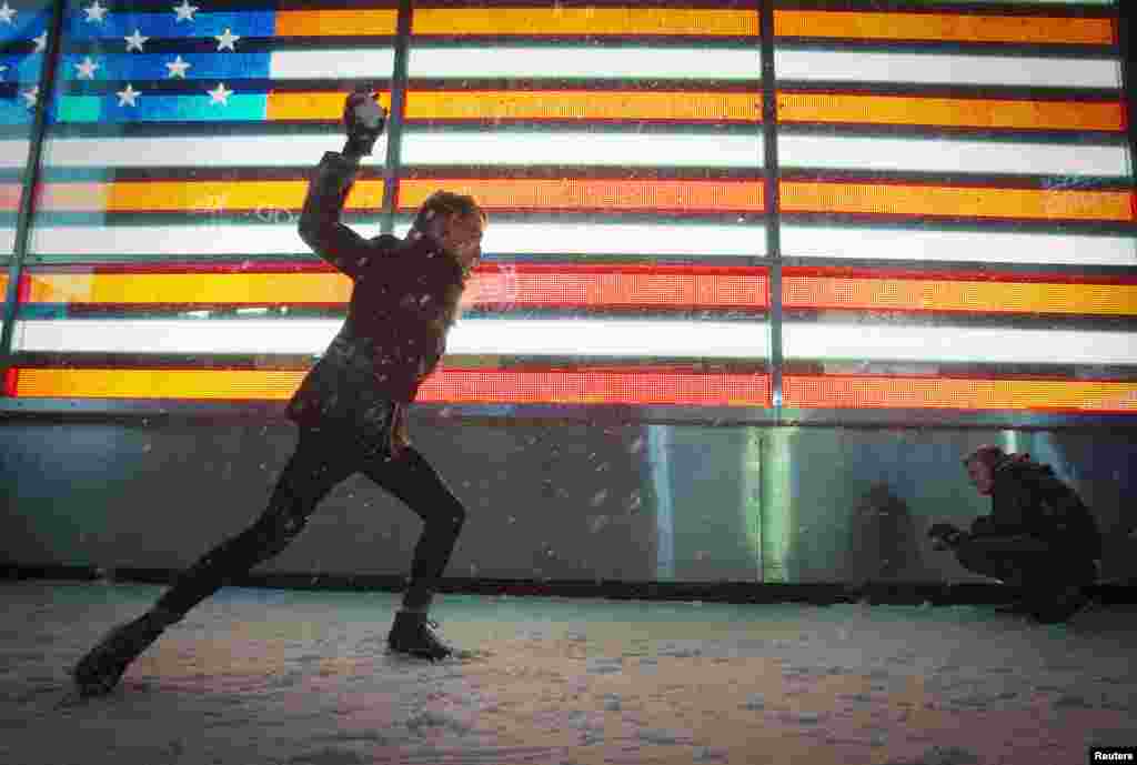 People have a snowball fight in Times Square in New York, Jan. 3, 2014. 