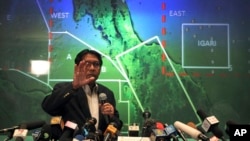 FILE - Malaysia's Department of Civil Aviation's Director General Azharuddin Abdul Rahman briefs reporters on search and recovery efforts within existing and new areas for missing Malaysia Airlines plane during a press conference, Monday, March 10, 2014 in Sepang, Malaysia.