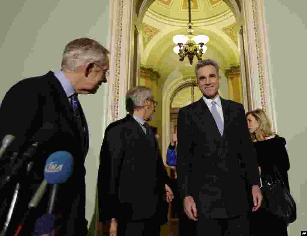 Senate Majority Leader Harry Reid, left, with director Steven Spielberg, center, and cast member Daniel Day-Lewis, before a screening of the movie "Lincoln," for members of Congress, on Capitol Hill, December 19, 2012.