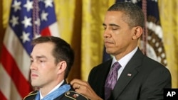 President Barack Obama bestows the Medal of Honor on retired Staff Sgt. Clinton Romesha for conspicuous gallantry, Feb. 11, 2013, in the East Room of the White House.
