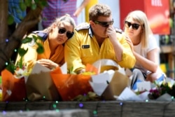Members of the Horsley Park RFS honor volunteer firefighters Andrew O'Dwyer and Geoffrey Keaton, who died when their firetruck was struck by a falling tree as it traveled through the front line of a fire, in Horsley Park, NSW, Dec. 20, 2019.