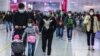 People wearing facemasks walk through a train station on the second day of the Lunar New Year of the Rat in Hong Kong on January 26, 2020, as a preventative measure following a coronavirus outbreak which began in the Chinese city of Wuhan.