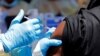 FILE - A health worker injects a man with Ebola vaccine in Goma, Democratic Republic of the Congo, Aug. 5, 2019.