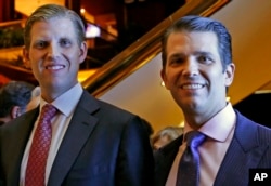 FILE - Eric Trump, left, and Donald Trump Jr., executive vice presidents of The Trump Organization, pose for a photograph at an event for Scion Hotels, a division of Trump hotels, June 5, 2017, in New York.
