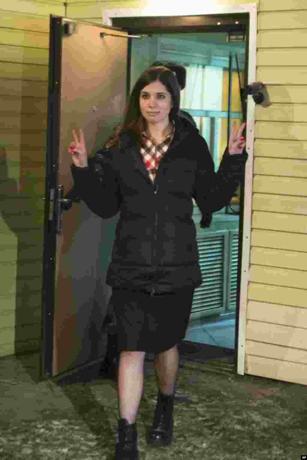Nadezhda Tolokonnikova gestures as she leaves prison in Krasnoyarsk, Russia, Dec. 23, 2013. 