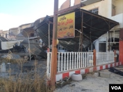 FILE - Recaptured cities and villages surrounding Mosul are in ruins, with electricity and water cut and buildings in rubble in Bartella, Iraq, Nov. 2 , 2016. (H. Murdock/VOA)