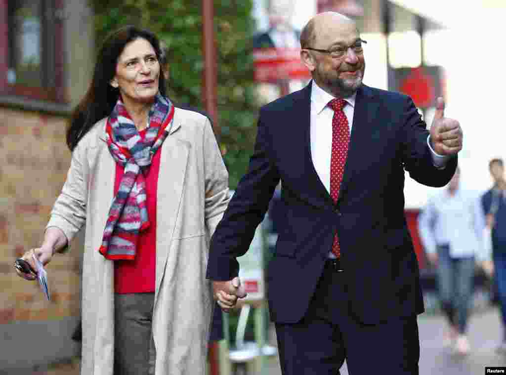 Social Democratic Party SPD leader and top candidate Martin Schulz and his wife Inge arrive at a poling station during the general election in Wuerselen, Germany, Sept. 24, 2017.