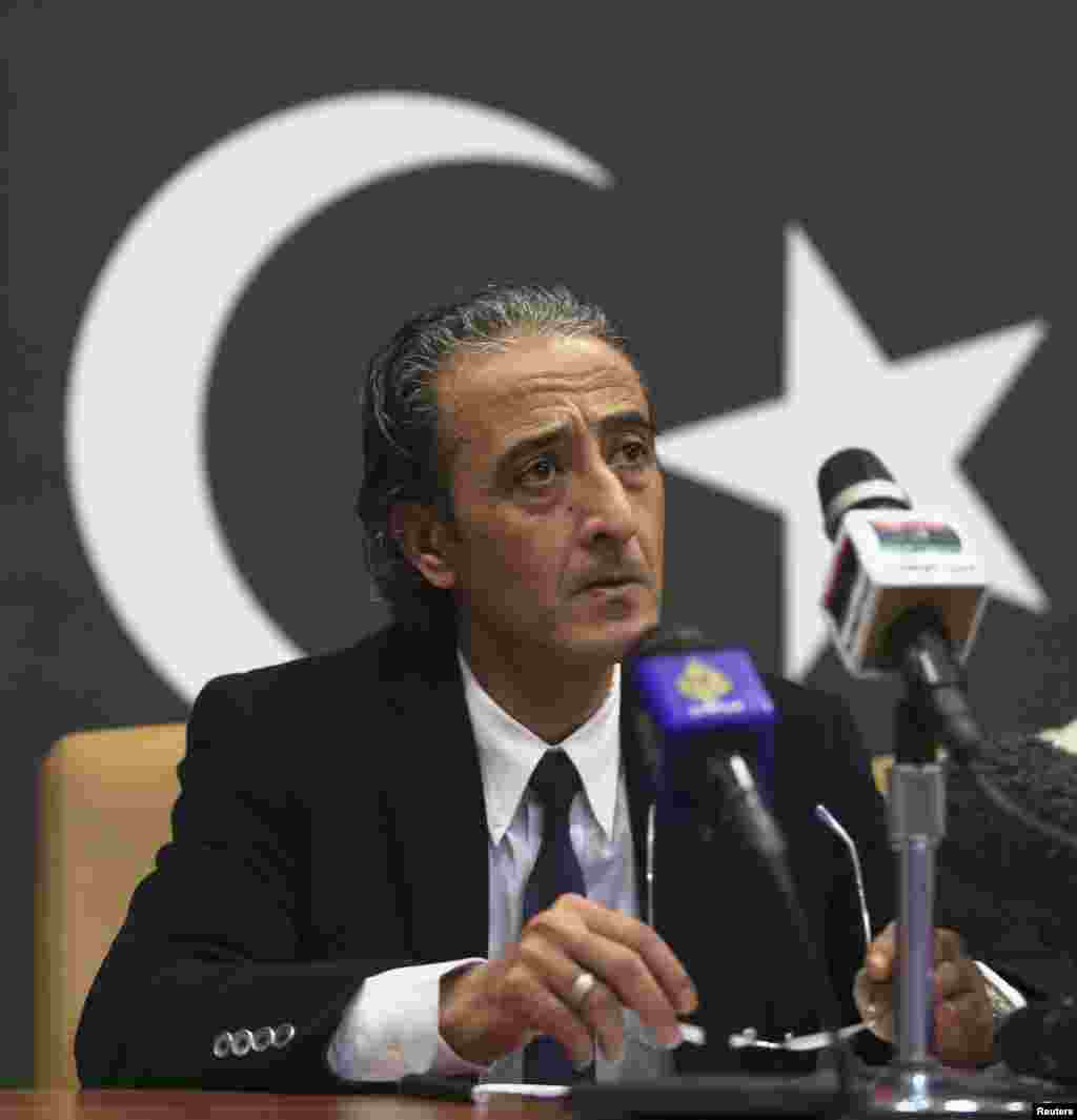Minister of Culture and Civil Society Habib Mohammed Al-Amin speaks during a news conference about a suicide attack on the checkpoint of Barsis, in Benghazi, Libya, Dec. 22, 2013. 
