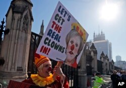 A Demonstrator protests at the entrance of the Houses of Parliament in London, Feb. 26, 2019.