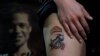 A woman who goes by the single name Mary shows off a tattoo of a Hong Kong protester clad in protective gear by artist Mike Chan in Hong Kong, Oct. 23, 2019. 