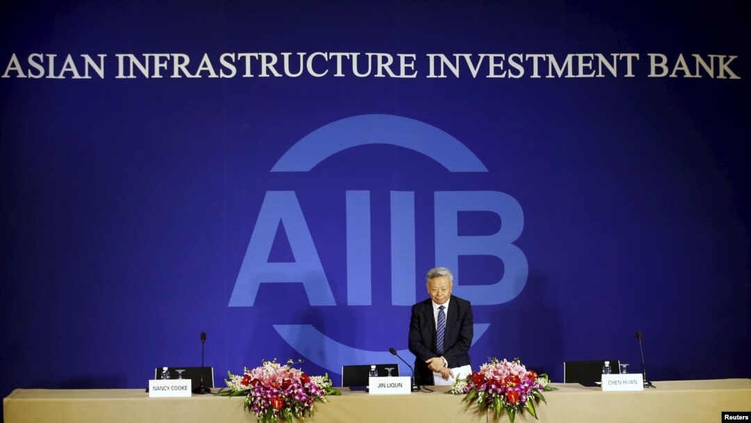 President of Asian Infrastructure Investment Bank (AIIB) Jin Liqun greets to journalists as he arrives at a news conference in Beijing, Jan. 17, 2016.