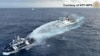 A China Coast Guard ship (R) deploying water cannon at the Phillipine Bureau of Fisheries and Aquatic Resources vessel BRP Datu Pagbuaya (L) near Scarborough Shoal in disputed waters of the South China Sea, Dec. 4, 2024. (National Task Force for the West Philippine Sea/Handout)