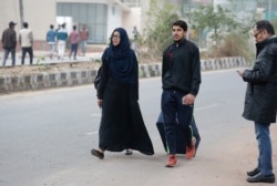 A student of Jamia Millia Islamia university leaves a day after police stormed their campus in New Delhi, Dec.16, 2019.