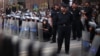 Police stand guard during a protest against the military council outside Egypt's parliament in Cairo, June 19, 2012. 