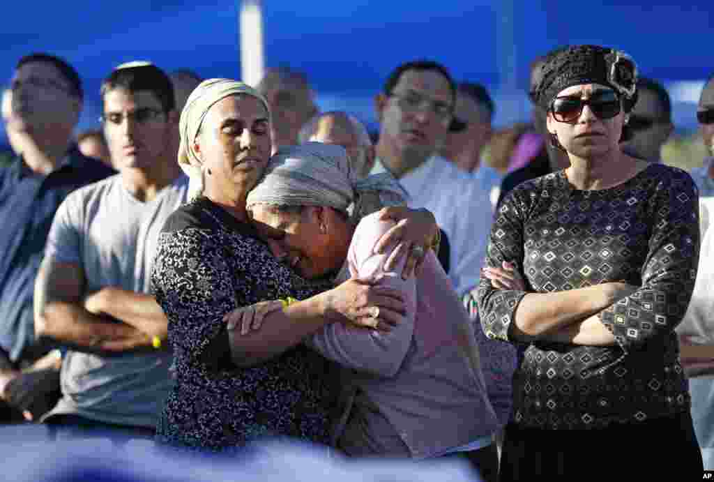 Bat-Galim Shaar, right, and Iris Yifrah, center, mothers of two of the three Israeli teens who were abducted and killed in the West Bank, mourn during the joint funeral of their sons in Modiin, July 1, 2014.