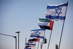 FILE - The national flags of Israel and the United Arab Emirates flutter along a highway following the agreement to formalize ties between the two countries, in Netanya, Israel, Aug. 17, 2020.