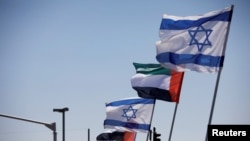 FILE - The national flags of Israel and the United Arab Emirates flutter along a highway following the agreement to formalize ties between the two countries, in Netanya, Israel, Aug. 17, 2020. 