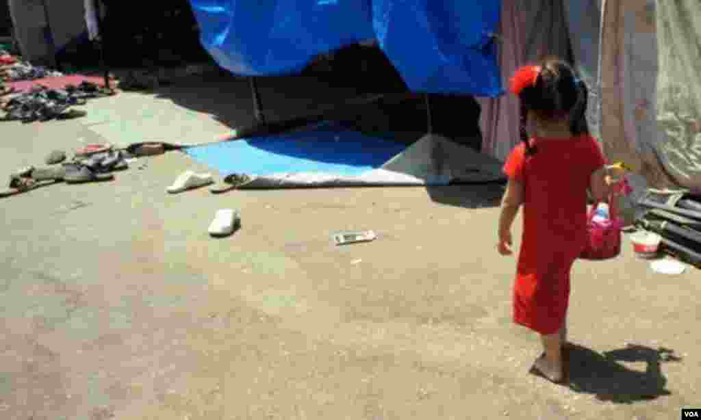 A young girl heads back to her tent at the protest encampment, Cairo, August 12, 2013. (E. Arrott/VOA) 