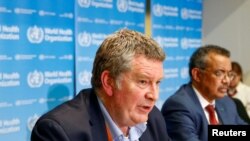 FILE - Executive Director of the World Health Organization's emergencies program Mike Ryan, L, speaks at a news conference on the novel coronavirus in Geneva, Switzerland, Feb. 6, 2020.