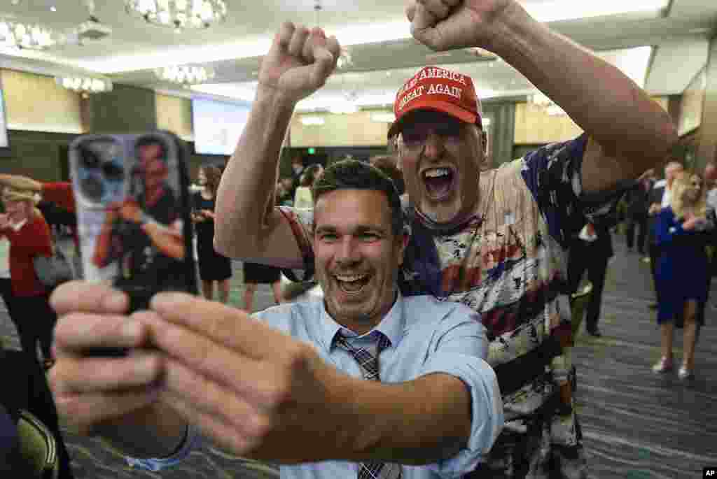 Supporters celebrate and take selfies during an election watch party for Republican U.S. Senate candidate Eric Hovde, in Madison, Wisconsin, Nov. 6, 2024. 