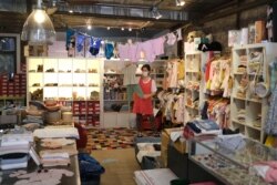 Dominique Simonneaux, owner of Les Petits Chapelais, works to fulfill online orders at her store in the Soho neighborhood of New York, June 8, 2020.