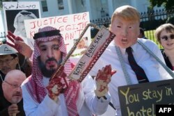 Demonstrators dressed as Saudi Arabian Crown Prince Mohammed bin Salman and US President Donald Trump (C) protest outside the White House in Washington, DC, on Oct. 19, 2018, demanding justice for missing Saudi journalist Jamal Khashoggi.