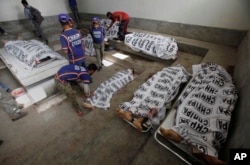 Bodies of alleged militants killed in an operation by security forces are tended to by workers from the Chhipa Welfare Association, at a mortuary in Karachi, Pakistan, Feb. 22, 2017. Rao Anwar, a police official in Karachi, said eight Taliban-linked militants were killed in the raid.