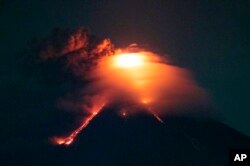 Lava cascades down the slopes of Mayon volcano as seen from Legazpi city, Albay province, around 340 kilometers (210 miles) southeast of Manila, Philippines, Monday, Jan. 15, 2018.