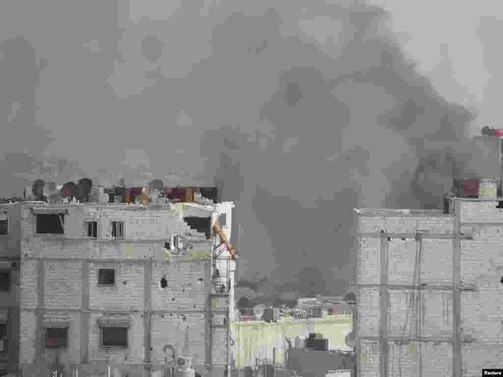 Smoke rises after what activists said was shelling by forces loyal to Syria's President Bashar al-Assad in Homs, April 1, 2013.