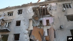 In this photo provided by the Ukrainian Emergency Service, a damaged apartment house is seen after Russia attacked the city with guided bombs overnight in Zaporizhzhia, Ukraine, Sept. 29, 2024. 