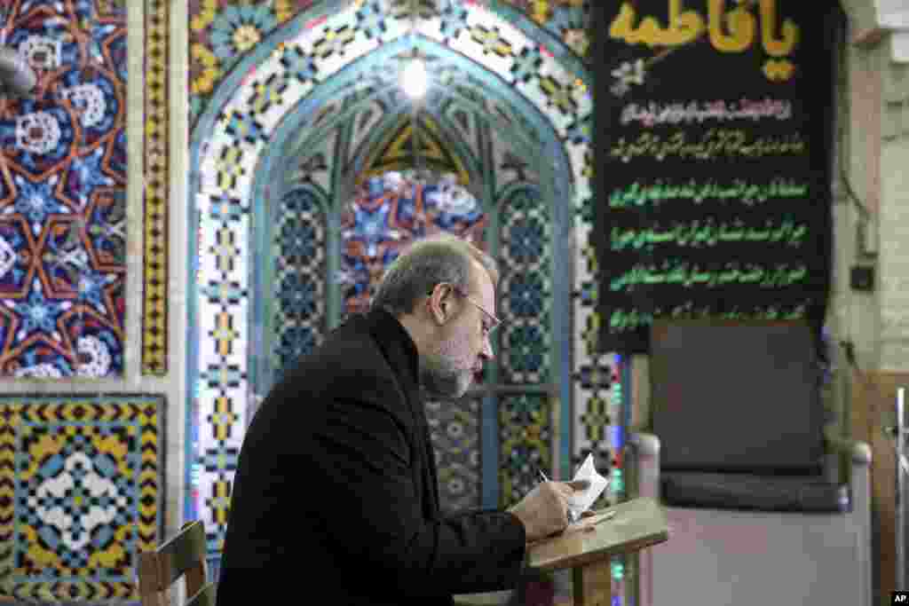Iran's Parliament Speaker Ali Larijani votes in the parliamentary and Experts Assembly elections at a polling station in Qom, Feb. 26, 2016.