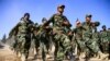 FILE - Afghan National Army soldiers march during a ceremony at a military base in the Guzara district of Herat province, Oct. 11, 2020. 