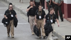 U.S. secret service agents walk around the Convention Center in Cartagena, Colombia, prior to the opening ceremony of the 6th Summit of the Americas, April 14, 2012.