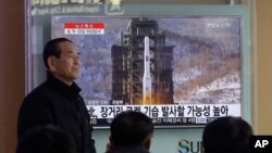 Warga Korea Selatan menyaksikan penayangan rencana peluncuran roket Korea Utara yang disiarkan melalui televisi di sebuah stasiun kereta api di Seoul, Korea Selatan (3/2). 