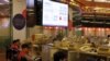 A display board shows the falling Hang Seng Index during morning trading on the first day of trading after Lunar New Year holidays at the Hong Kong Stocks Exchange in Hong Kong, China, Feb. 11, 2016. 