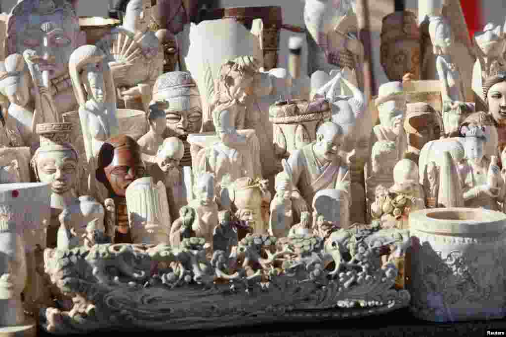 Dozens of confiscated carved ivory sculptures are displayed before 6 tons of ivory was crushed in Denver, Colorado, Nov. 14, 2013.