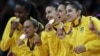 Members of the Brazil women's volleyball team show off their gold medals following a 3-1 win over the United States during the women's gold medal volleyball match at the 2012 Summer Olympics, Saturday, Aug. 11, 2012, in London. 