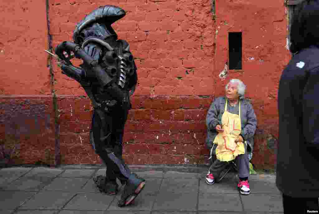 A person dressed in a movie costume walks near Saint Rose's Church during celebrations of the anniversary of Santa Rosa de Lima (Saint Rose of Lima), patroness of Latin America and the Philippines, in Lima, Peru, Aug. 30, 2016.