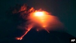 Lava cascades down the slopes of Mayon volcano as seen from Legazpi city, Albay province, around 340 kilometers (210 miles) southeast of Manila, Philippines, Monday, Jan. 15, 2018. 