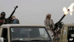 FILE - A Houthi rebel fighter fires in the air during a gathering aimed at mobilizing more fighters for the Houthi movement, in Sana'a, Yemen, Aug. 1, 2019. 