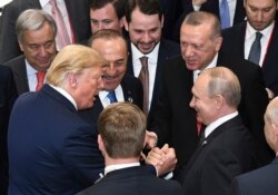 FILE - U.S. President Donald Trump, left, shakes hands with Russian President Vladimir Putin, right, as Turkey's President Recep Tayyip Erdogan, second right, looks on, in Osaka, Japan, June 29, 2019.