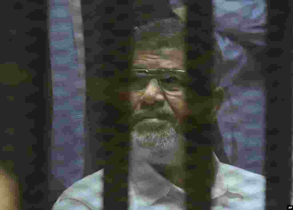 Egypt's ousted Islamist president Mohamed Morsi sits in a soundproof glass cage at Egypt’s national police academy in Cairo, April 21, 2015.