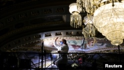 Restoration work is done on the ceiling inside the Senate reception room while the Senate works to finalize the bipartisan infrastructure deal at the U.S. Capitol in Washington, Aug. 5, 2021. 
