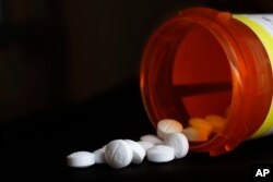 FILE - An arrangement of Oxycodone pills is seen in New York, Aug. 29, 2018.