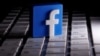 FILE - A 3-D-printed Facebook logo is seen placed on a keyboard in this illustration.