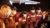 Medical experts from China stand at the Nikola Tesla airport after arriving with medical supplies to help the country's fight against the coronavirus in Belgrade, Serbia, March 21, 2020.