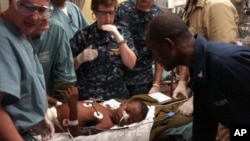Medical professionals aboard the Military Sealift Command hospital ship USNS Comfort treat a six-year-old Haitian boy in the casualty receiving room aboard the 1,000-bed hospital ship, 19 Jan 2010