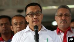FILE - Indonesian Youth and Sports Minister Imam Nahrawi, center, speaks to the media during a press conference in Jakarta, Indonesia, Sept. 19, 2019.